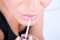 Woman applying lipgloss