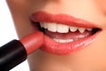 Woman applying lipstick beauty cosmetics to lips Royalty Free Stock Photo