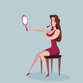 Woman applying lipstick looking at mirror in hand Royalty Free Stock Photo