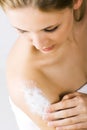 Woman applying lotion Royalty Free Stock Photo