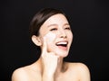 Woman applying lotion cream on face Royalty Free Stock Photo