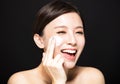 Woman applying lotion cream on face Royalty Free Stock Photo