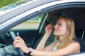 Woman applying make-up while driving car. Royalty Free Stock Photo