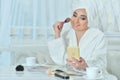 Woman applying make up Royalty Free Stock Photo