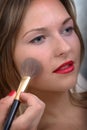 Woman applying makeup Royalty Free Stock Photo