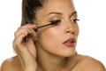Woman applying mascara on her eyelashes Royalty Free Stock Photo