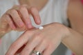 Woman applying moisturize cream on hands Royalty Free Stock Photo