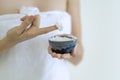 Woman applying Moisturizer cream or Scrub Lotion on hands treatment in spa salon Royalty Free Stock Photo