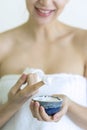 Woman applying Moisturizer cream or Scrub Lotion on hands treatment in spa salon Royalty Free Stock Photo