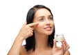 Woman applying moisturizing cream