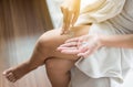 Woman applying moisturizing cream on her leg,Concept healthy and skin Royalty Free Stock Photo