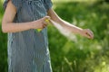 Woman applying mosquito repellent on the hand skin in the forest Royalty Free Stock Photo