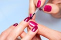 Woman applying nail varnish to finger nails Royalty Free Stock Photo