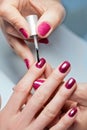 Woman applying nail varnish to finger nails Royalty Free Stock Photo