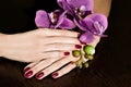 Woman applying nail varnish to finger nails