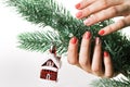 Woman applying nail varnish to finger nails and fir tree Royalty Free Stock Photo