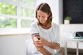 Woman Applying Patch On Her Arm Royalty Free Stock Photo