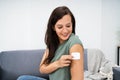 Woman Applying Patch On Her Arm Royalty Free Stock Photo