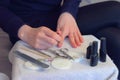 Woman is applying primer on nails before cover it shellac gel polish, closeup.