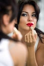 Woman applying red lipstick Royalty Free Stock Photo