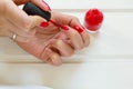 Woman applying red nail polish manicure. Female hand Royalty Free Stock Photo