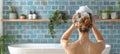 Woman applying shampoo in shower of a stylish modern bathroom for hair washing routine Royalty Free Stock Photo