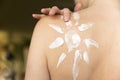 Woman applying sunscreen cream to protect skin from sunburn before sunbathing at beach