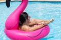 Woman applying sunscreen at sunny summer poolside