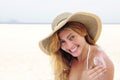 Woman applying suntan lotion at the beach Royalty Free Stock Photo