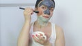 Woman applying three various face masks