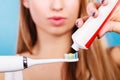 Woman applying toothpaste on her toothbrush Royalty Free Stock Photo