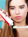 Woman applying toothpaste on her toothbrush Royalty Free Stock Photo