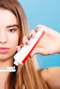 Woman applying toothpaste on her toothbrush Royalty Free Stock Photo