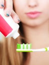 Woman applying toothpaste on her toothbrush Royalty Free Stock Photo