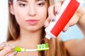 Woman applying toothpaste on her toothbrush Royalty Free Stock Photo