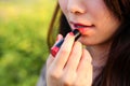 Woman applying or wearing cosmetic lipstick, red ,pink ,make up Royalty Free Stock Photo