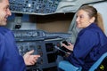 woman apprentice questioning man in cockpit aircraft Royalty Free Stock Photo