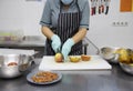 Woman in apron cutting apples for baking pie Royalty Free Stock Photo