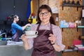 Woman in apron, food service coffee shop worker, small business owner with cup of coffee Royalty Free Stock Photo