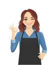 Woman in apron gesturing ok sign