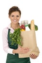 Woman in apron holding grocery bag Royalty Free Stock Photo