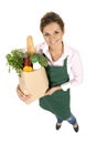 Woman in apron holding grocery bag Royalty Free Stock Photo