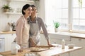 Woman in apron hugs her mother posing in modern kitchen Royalty Free Stock Photo