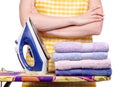 Woman in apron with iron ironing board towels laundry clothes Royalty Free Stock Photo