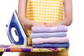 Woman in apron with iron ironing board towels laundry clothes Royalty Free Stock Photo