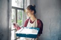 woman in apron painter repair painting window Royalty Free Stock Photo