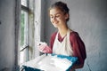 woman in apron painter repair painting window Royalty Free Stock Photo