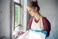 woman in apron painter repair painting window Royalty Free Stock Photo