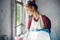 woman in apron painter repair painting window Royalty Free Stock Photo