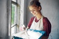 woman in apron painter repair painting window Royalty Free Stock Photo